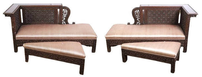 Pair of oak carved chaises with ottomans