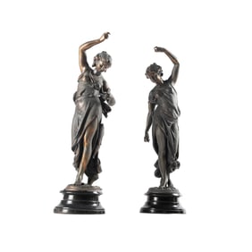 A Near Pair of Patinated White Metal Maiden Figures