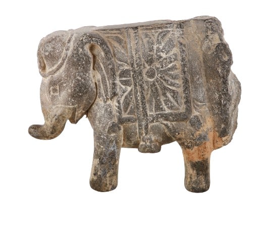 Indian Gandhara grey schist elephant figure: Indian Gandhara grey schist figurine, elephant wearing a blanket and sunburst, 200-400 AD, 4-1/4" h x 5-1/2" w, on custom made acrylic stand