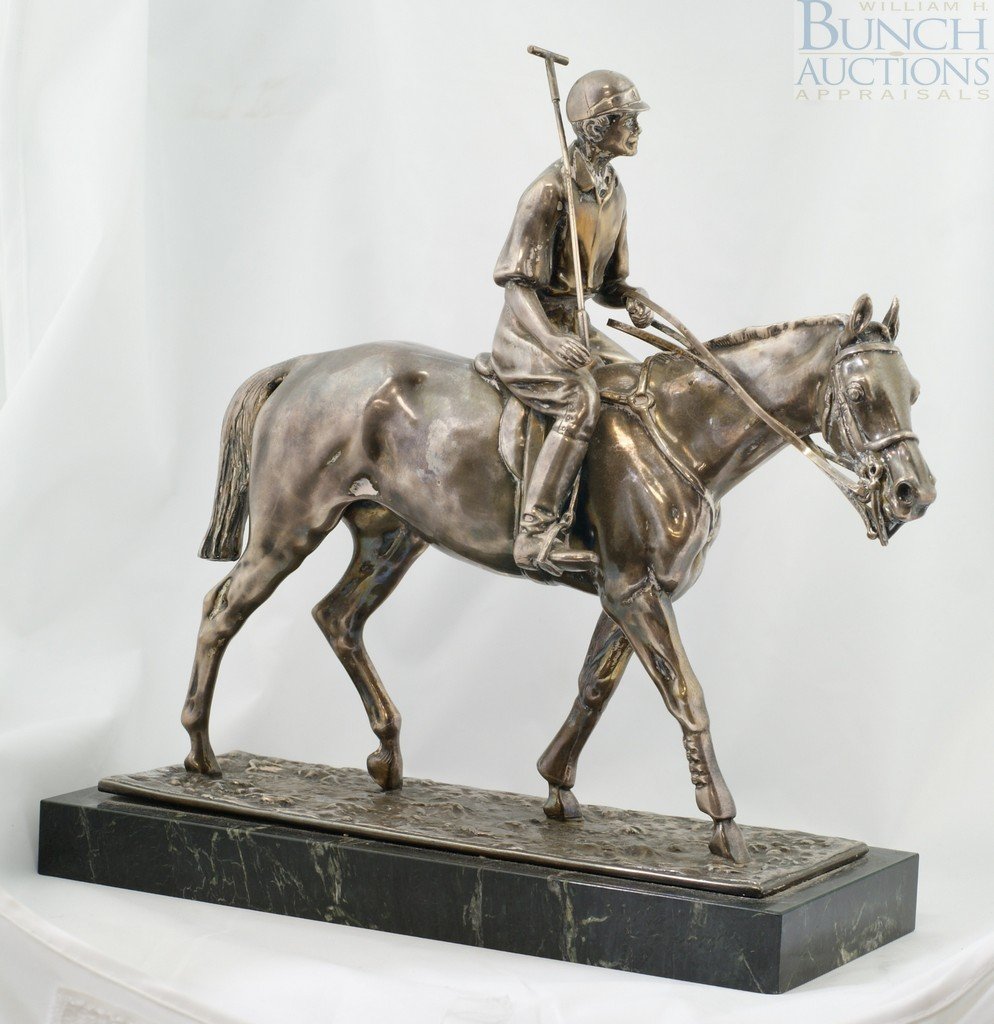 Plated silver sculpture of a polo player, on a b: Plated silver sculpture of a polo player, on a black marble base, marked JB 2876, on top of silver base, 10 3/4" h, 10 5/8" long at base