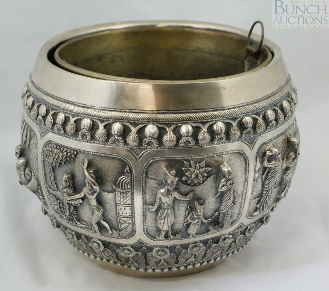 Unmarked silver wine cooler, possibly Persian, t: Unmarked silver wine cooler, possibly Persian, the body with overall repousse design in 8 panels depicting genre scenes, the base with an engraved peacock, with a silvered copper inner liner, 9 1/2" d
