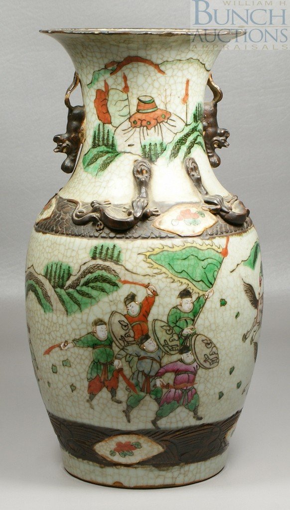 Chinese Wu Cai porcelain vase decorated with war: Chinese Wu Cai porcelain vase decorated with warriors in a battle scene, applied mythical creatures with losses, small chips around top, base with impressed mark, 13 7/8" h