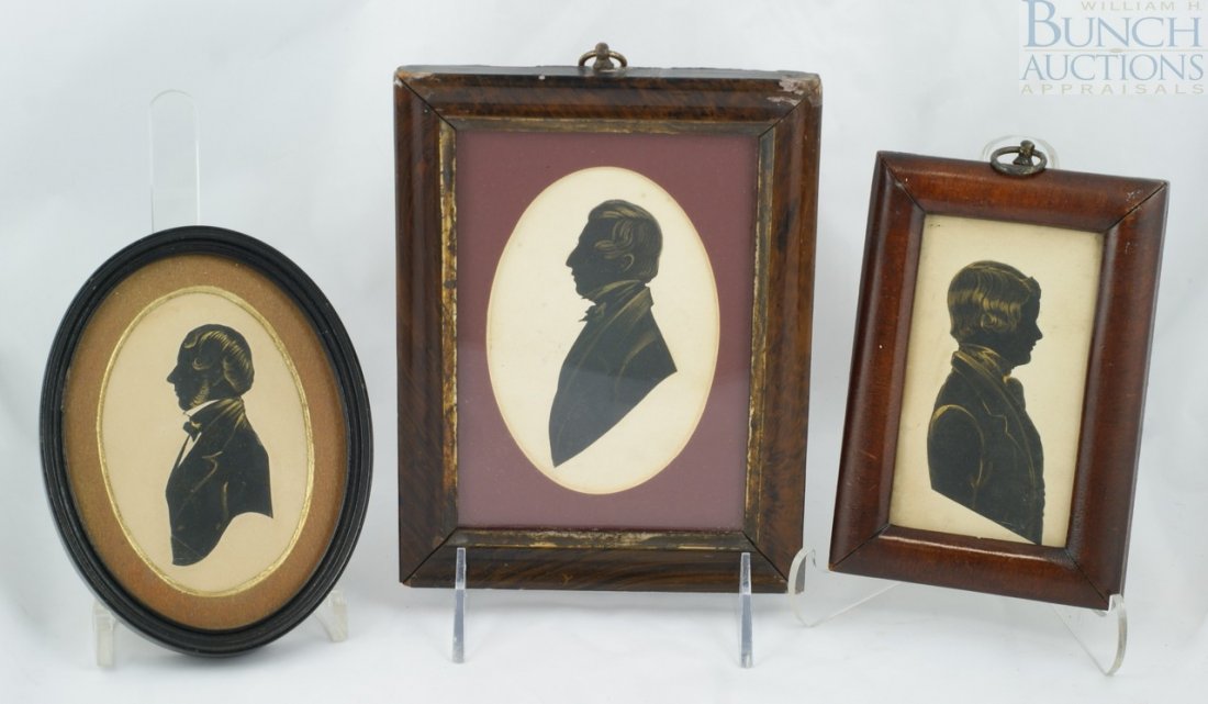 (3) Cut paper portraits to include a gentleman w: (3) Cut paper portraits to include a gentleman with gilt jacket, collar, hair, and beard housed in an oval wooden frame. Another gentleman with gilt hair, jacket, and collar housed in a veneered frame