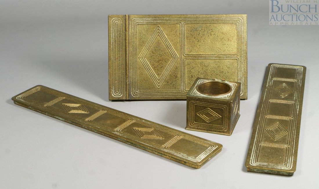 4-Piece Tiffany Studios bronze desk set, c/o no: 4-Piece Tiffany Studios bronze desk set, c/o note pad, 2 blotter corners, inkwell (missing lid), blotter corners approx 12" long, discoloration and oxidation evident