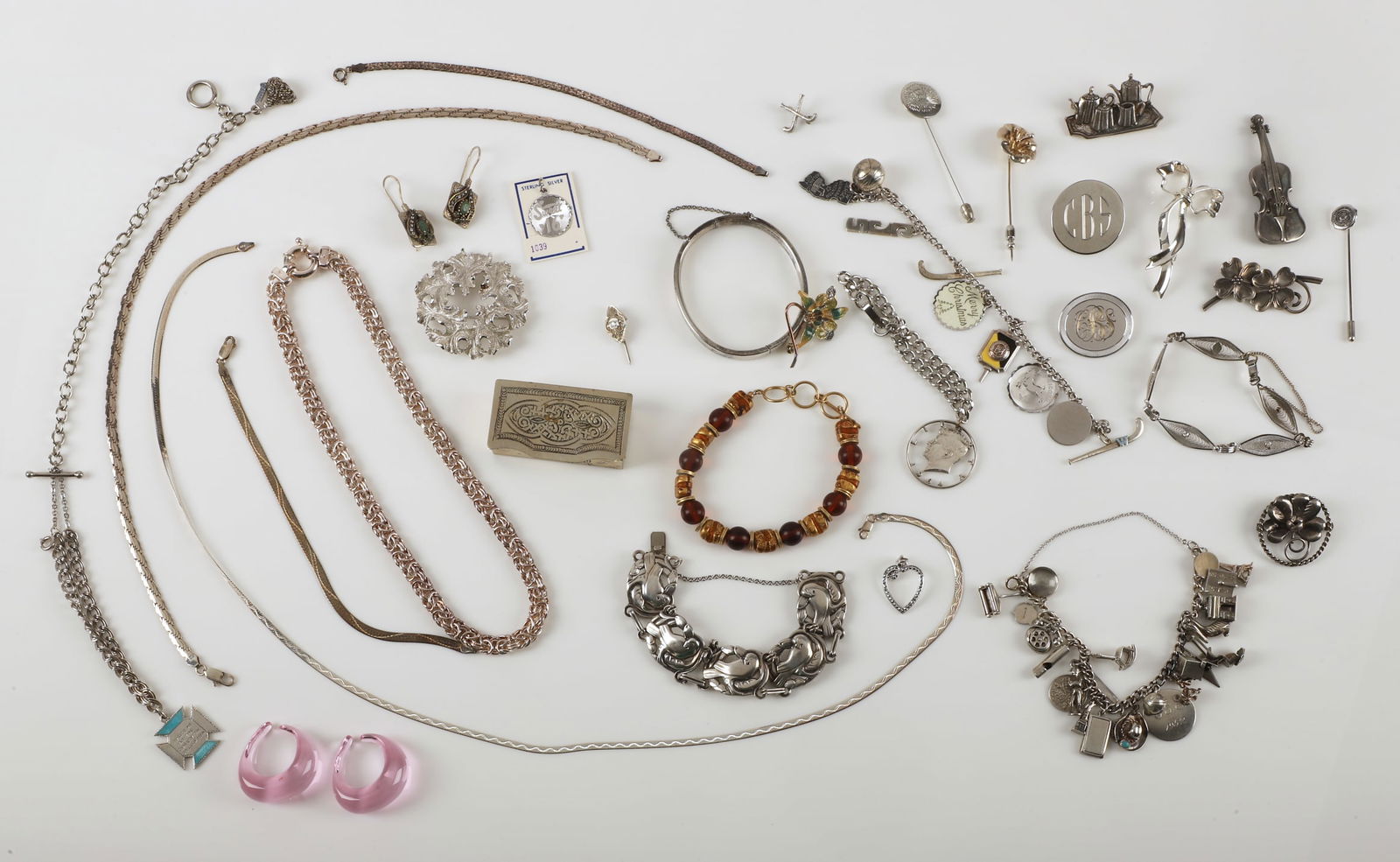 Assorted Sterling Jewelry Grouping: Assorted sterling jewelry grouping to include a 23-charm sterling bracelet, an 8-charm sterling bracelet, a pierced sterling Coro bracelet in Deco tastes, assorted sterling and silver brooches ,an Ita