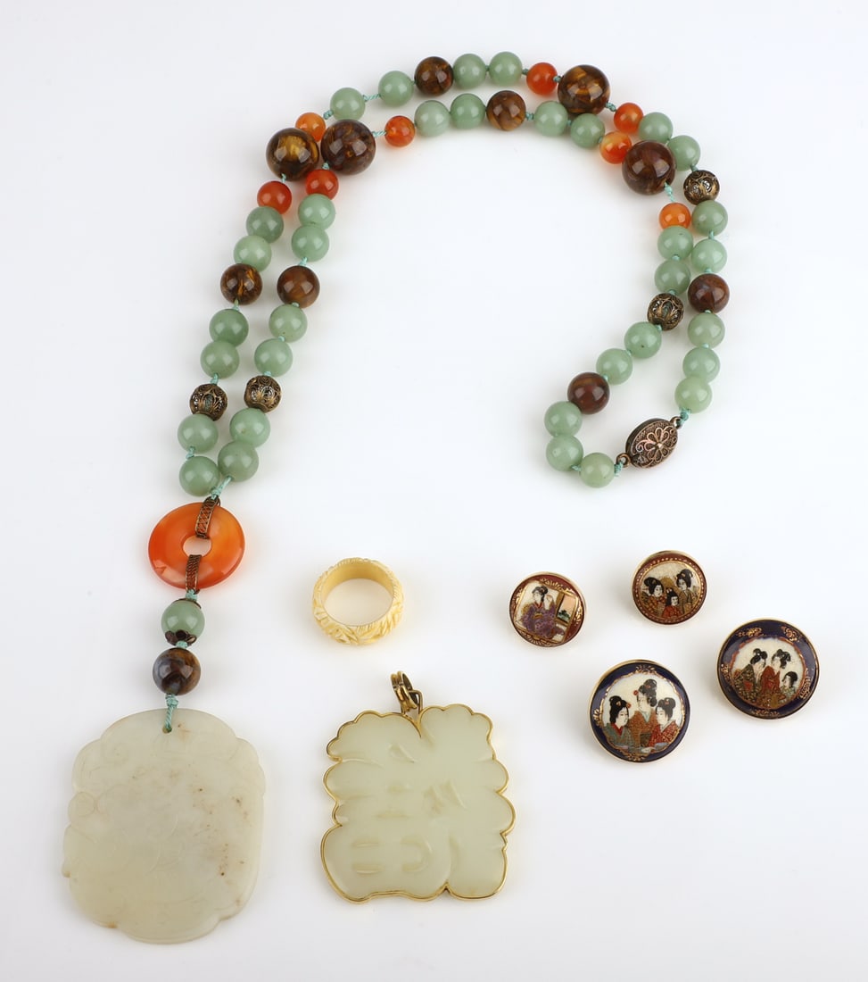 Asian Jewelry Grouping: Asian jewelry grouping to include a pierced hardstone pendant in 14K surround with 14K bale, 2 1/4"H, a hardstone, carnelian and silver necklace with silver closure, 36", a carved bone ring, and (2) p