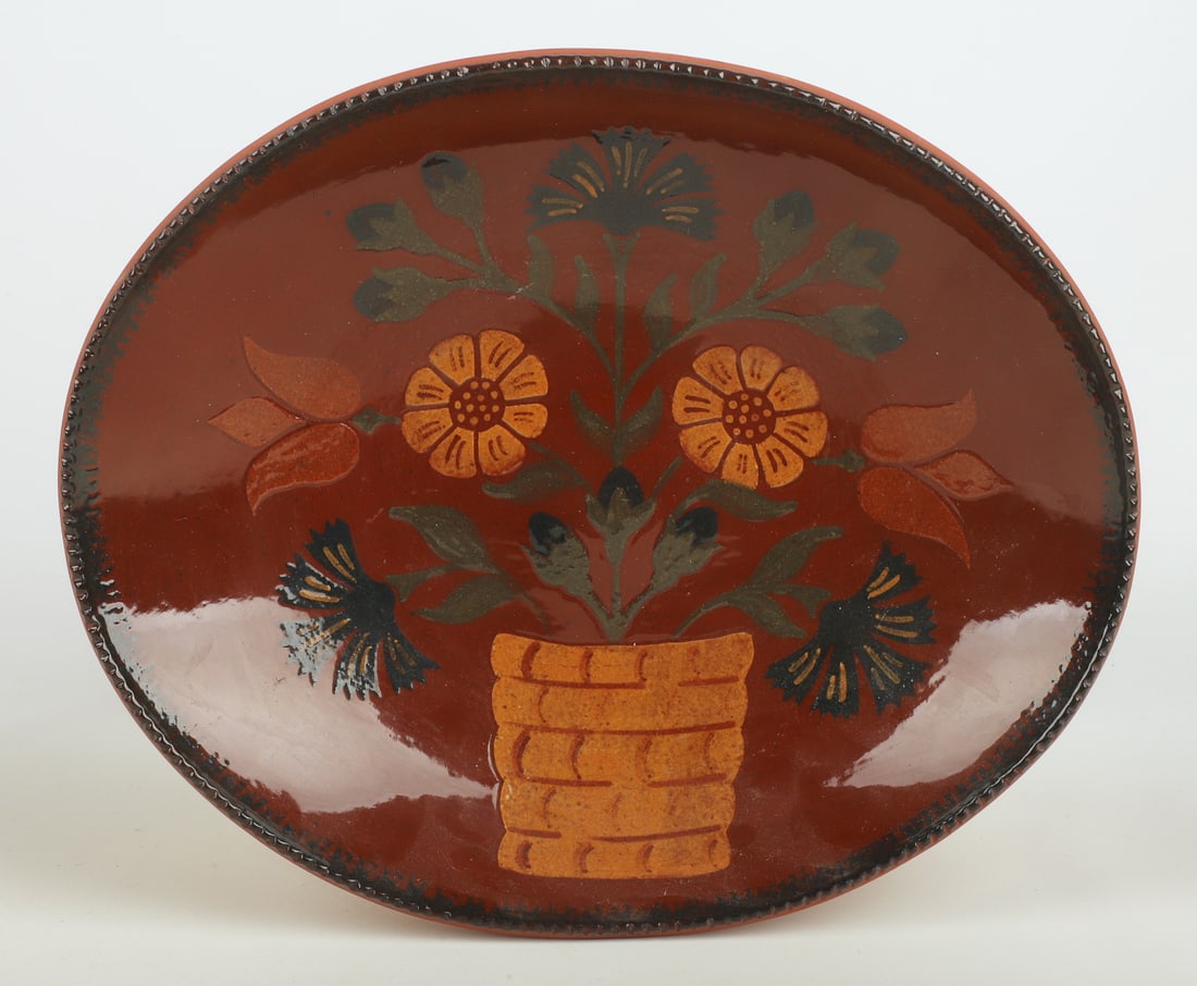 Foltz Pennsylvania redware pottery oval bowl: Foltz Pennsylvania redware pottery oval bowl with flower pot decoration, coggled edge, impressed and signed on back "Ned Foltz Reinholds Pa 1997", 12-3/4" x 10-1/2" x 2-1/4" h