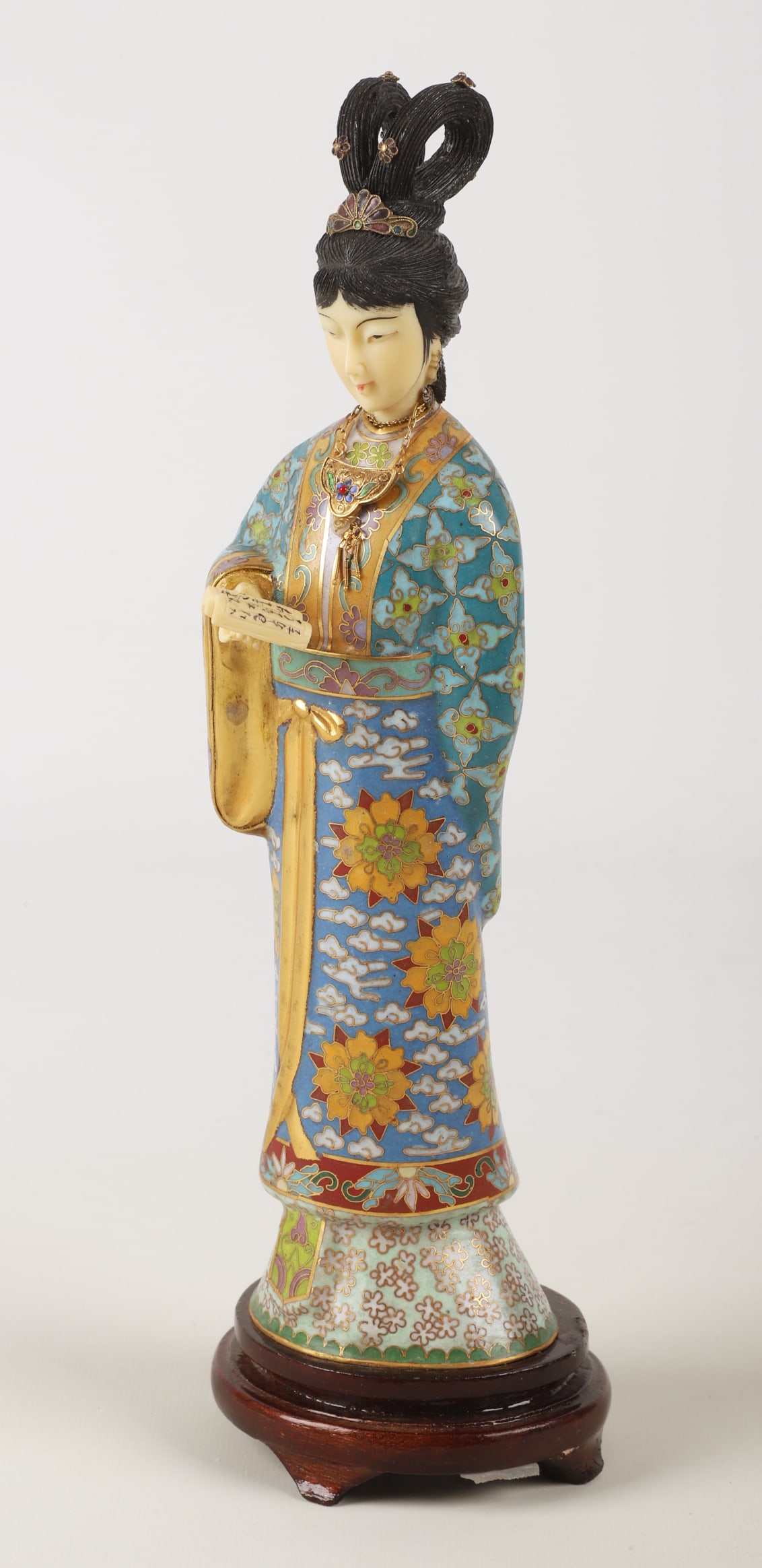 Chinese cloisonne figure: Chinese cloisonne figurine, woman holding book, composite face & hands, foil label ï¿½Zhen Huaï¿½ on base of attached wood stand, 12-1/2ï¿½ h