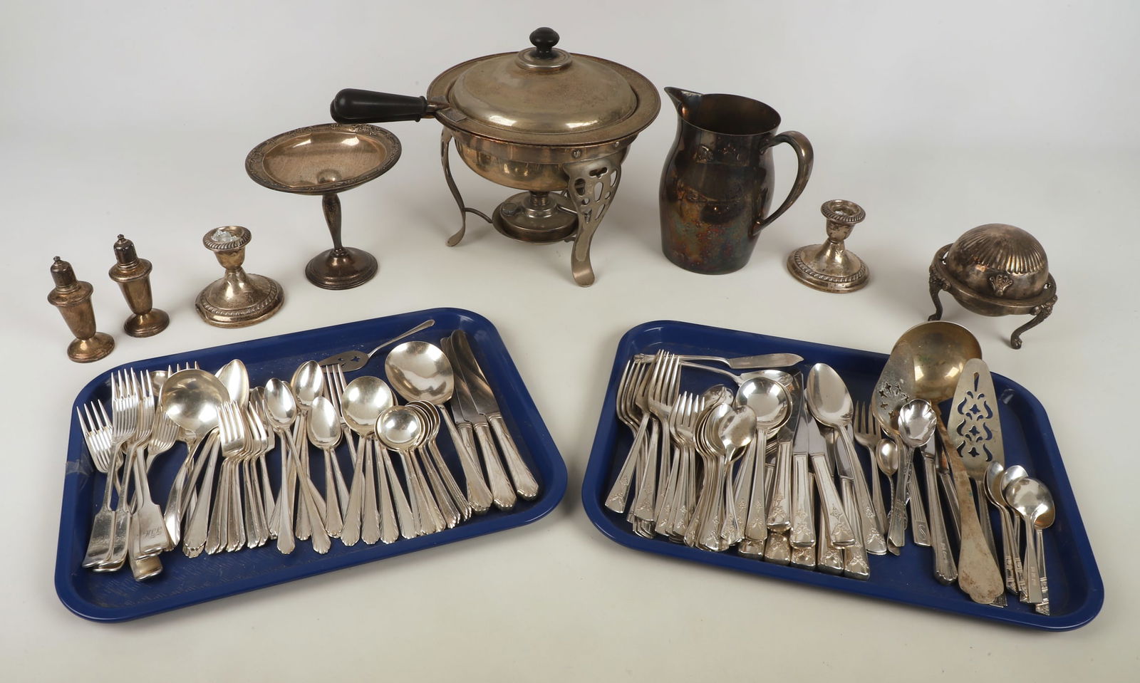 A Large Collection of Sterling Weighted and Plate: A Large Collection of Sterling Weighted and Plate to include (2) partial silverplate dinnerware sets, a collection of silverplate flatware and table items, a pair of sterling weighted candlesticks, de
