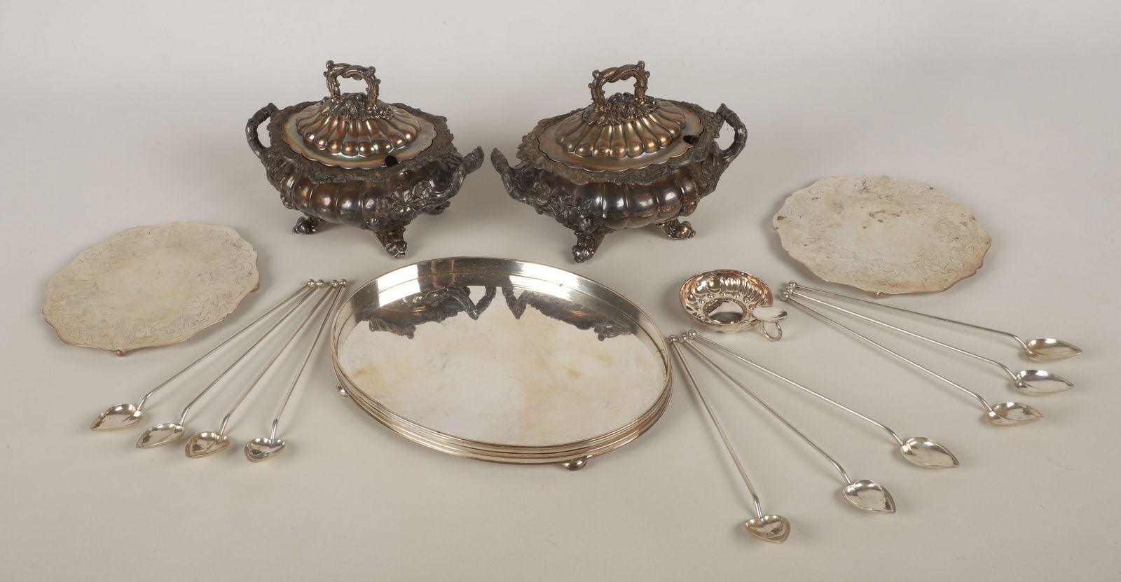 A Collection of Sterling and Silverplate Table Items: A Collection of Sterling and Silverplate Table Items to include (2) silverplated gadrooned and footed sauce tureens, a Sheffield oval silverplated tray, (2) silverplates trivets, Ravinet D'Enfert wine