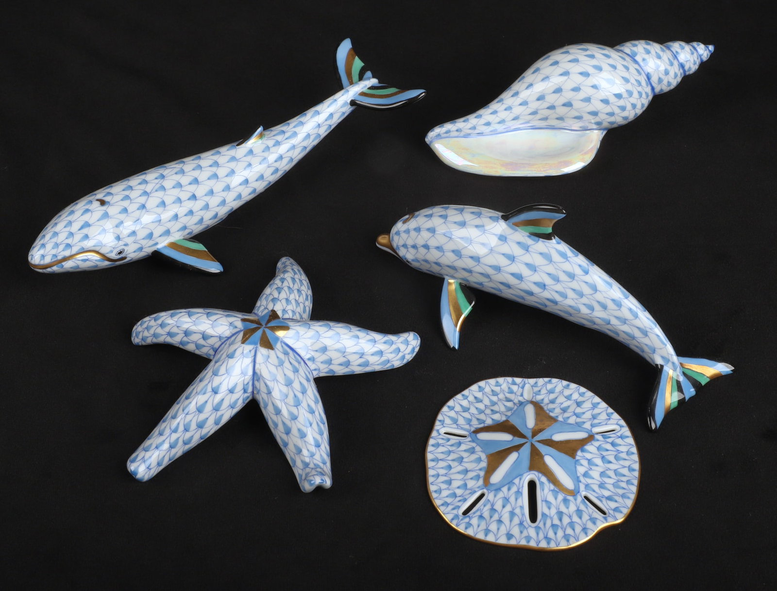 (5) Herend Fishnet Blue Seashells and Creatures: (5) Herend Fishnet Blue Seashells and Creatures to include a sand dollar, 2 7/8" dia, tulip shell, 5"L, dolphin, 5 3/4"L, starfish, 4 3/4" dia and whale, 6 1/2"L, some rubbing at underside where figur