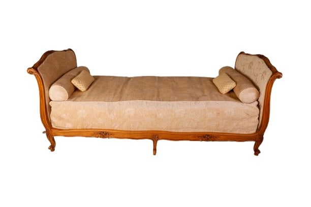 Fench style daybed: Fench style daybed, neutral floral and vine upholstery, mattress cover, upholstered box spring, (2) bolster pillows, (2) small throw pillows, (1) center leg repaired, (1) end of siderail repaired, 34"