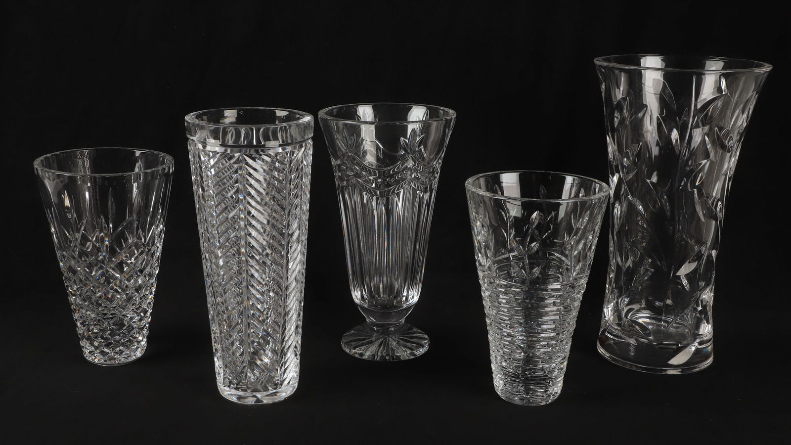 (5) Crystal Vases, Footed and Flared Rim: (5) Crystal Vases, Footed and Flared Rim, to include a crawling vine decorated vase, 7 7/8"H, a Lismore style flared rim vase, 8"H, a Waterford style flared rim footed vase, 9 5/8"H, a slim flared rim