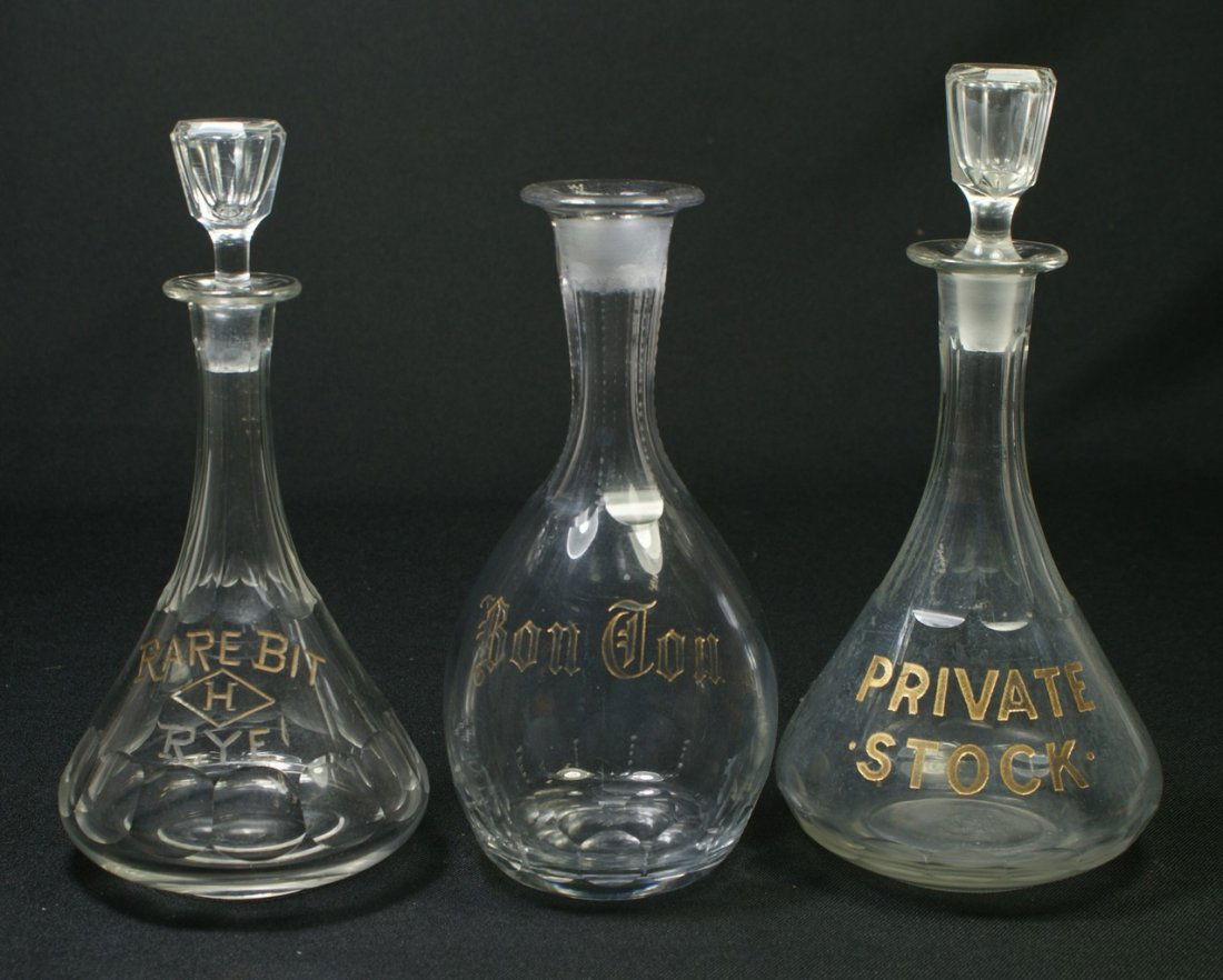3 clear glass back bar bottles with etched and g: 3 clear glass back bar bottles with etched and gilt decoration, PRIVATE STOCK, RARE BIT RYE, BON TON, tallest 10", one missing stopper, chippage on bottom of both stoppers