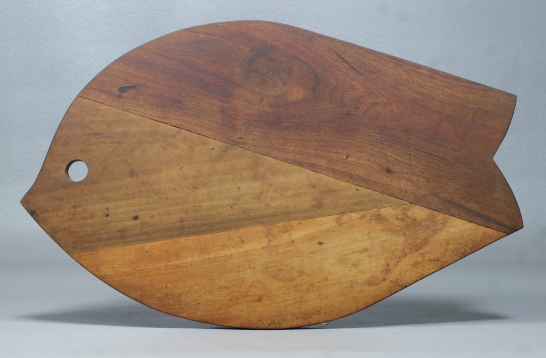 Walnut and cherry fish form cutting board purcha: Walnut and cherry fish form cutting board purchased from Wharton Esherick in 19XX, unsigned, accompanied by a notarized statement from the consignor as to the origin of the board, 17 1/2" long, 10 3/4
