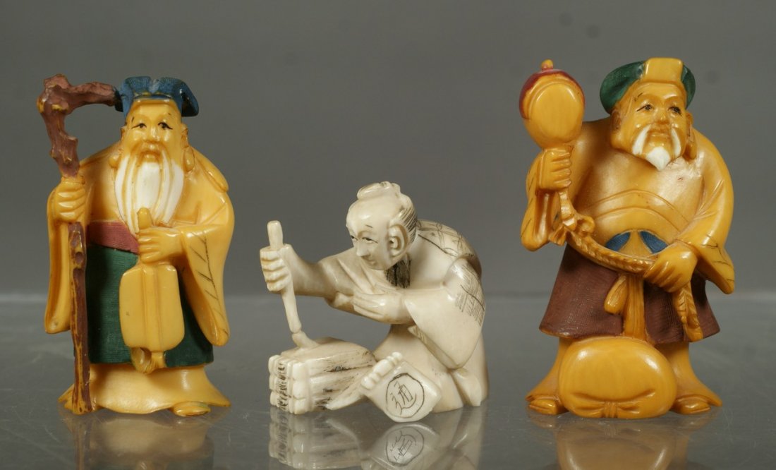 3 carved ivory netsuke, 2 tea stained elders, seated sc: 3 carved ivory netsuke, 2 tea stained elders, seated scribe, tallest 2", each signed. All items containing ivory or any other material from endangered species are sold subject to all applicable Federa
