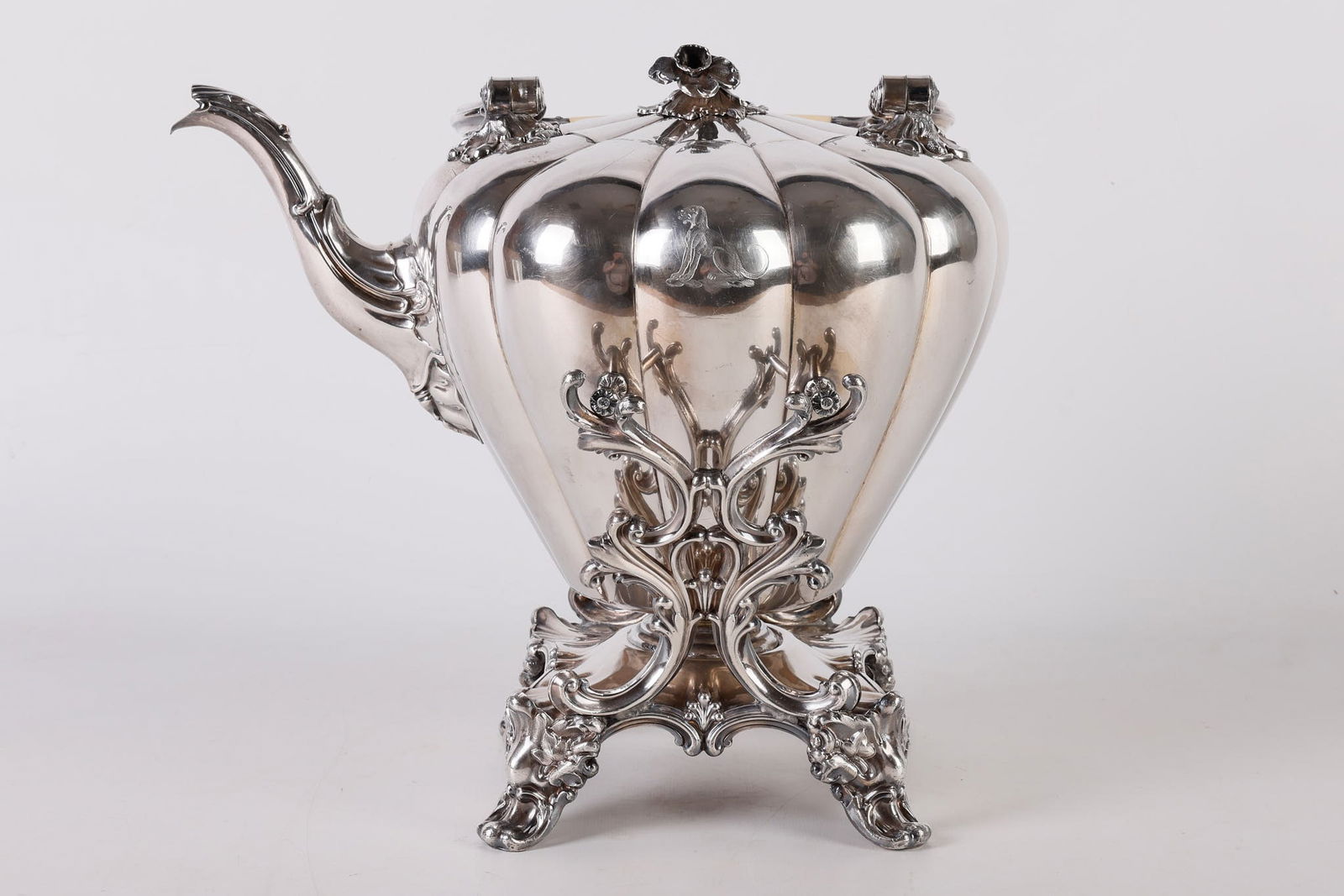 Monumental English Melon Form Tilting Teapot: Monumental English Melon Form Tilting Teapot, on stand, silverplated lobed body with figural leaf joined scrolling silverplate and bone handle, a hinged cover with blooming floral final, a seated dog