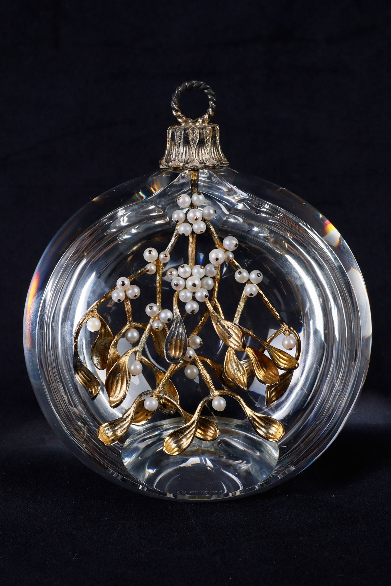 Steuben 'Mistletoe' Ornament Sculpture: Steuben 'Mistletoe' Ornament Sculpture, designed by Donald Pollard, a crystal ornament with sterling silver and cultured pearl formed mistletoe in worn gold vermeil at center, 5 3/4"H x 4 3/4" dia, si