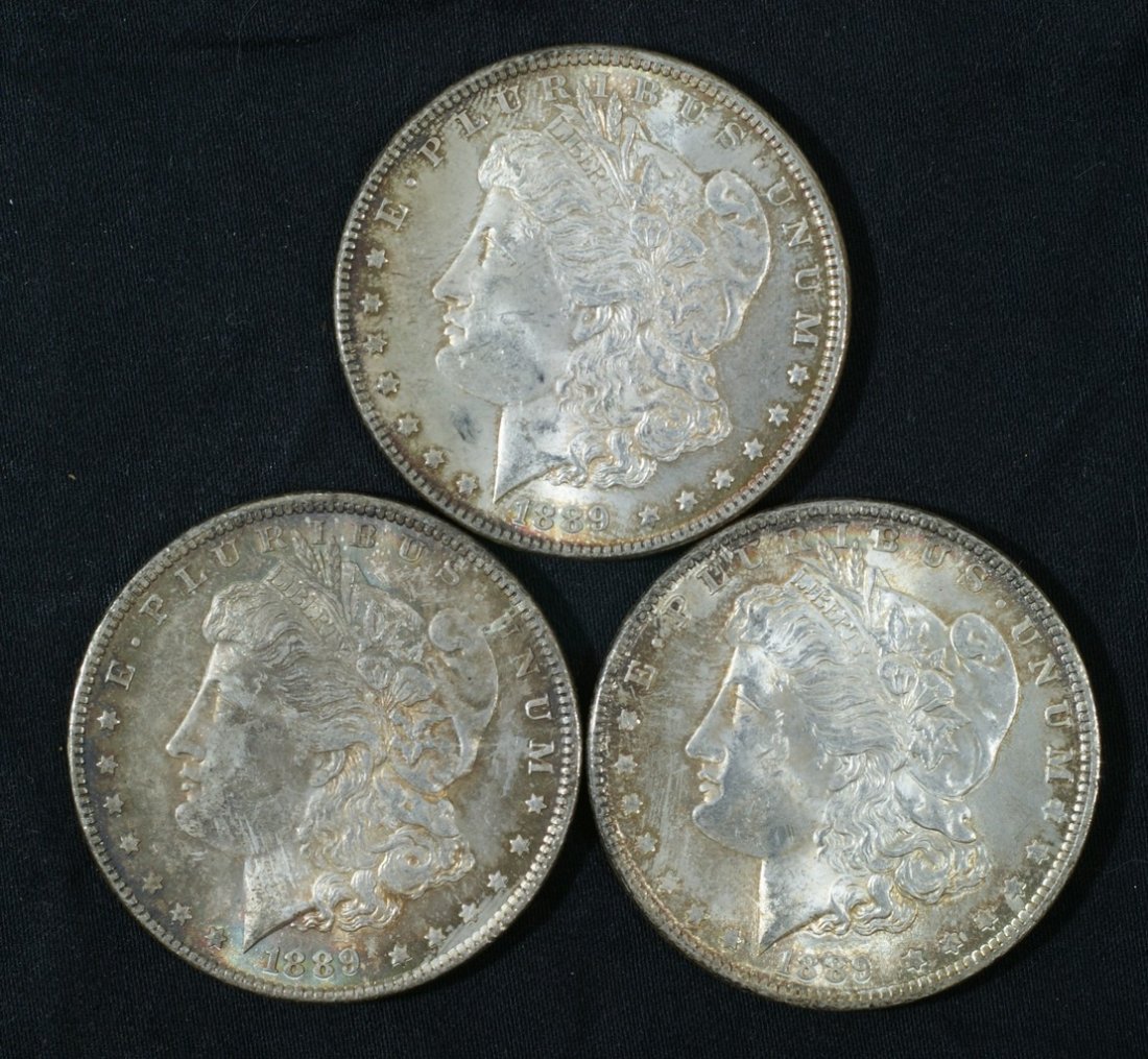 3 1889 Morgan dollars, all MS60 or better, nicely toned: 3 1889 Morgan dollars, all MS60 or better, nicely toned.