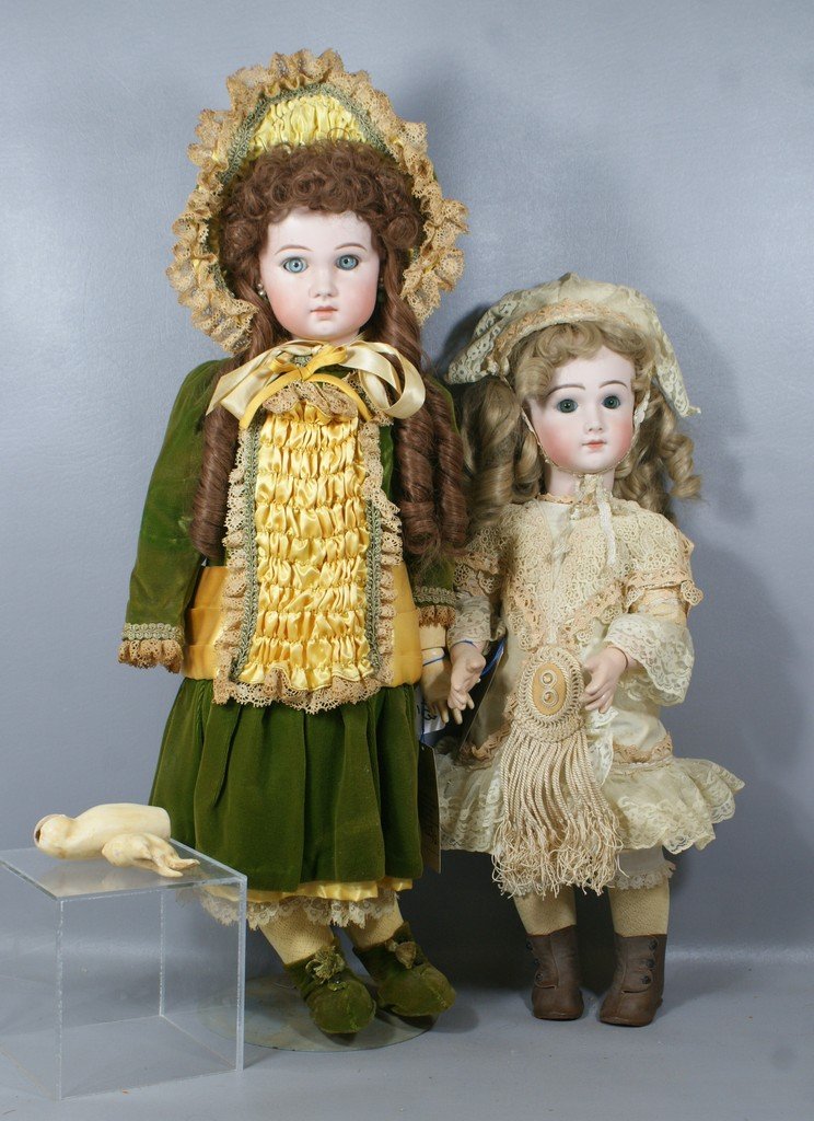 2 Reproduction French Dolls, the larger in a green dres: 2 Reproduction French Dolls, the larger in a green dress represents a Jumeau and the smaller an A.T., forearm and hand detached on larger doll, largest 26"