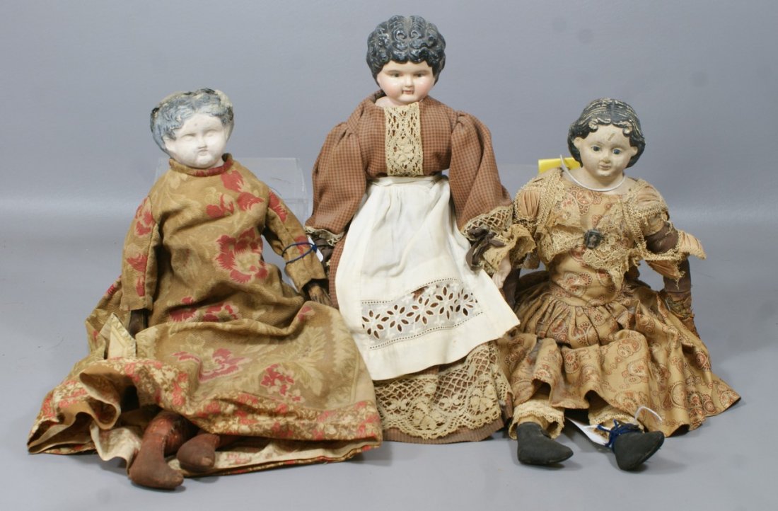 3 mid 19th century Papier Mache Shoulder dolls, includi: 3 mid 19th century Papier Mache Shoulder dolls, including a Greiner doll with original paper label from 1858, along with a heavier German Mache head wearing a white apron, and a third doll lacking mos