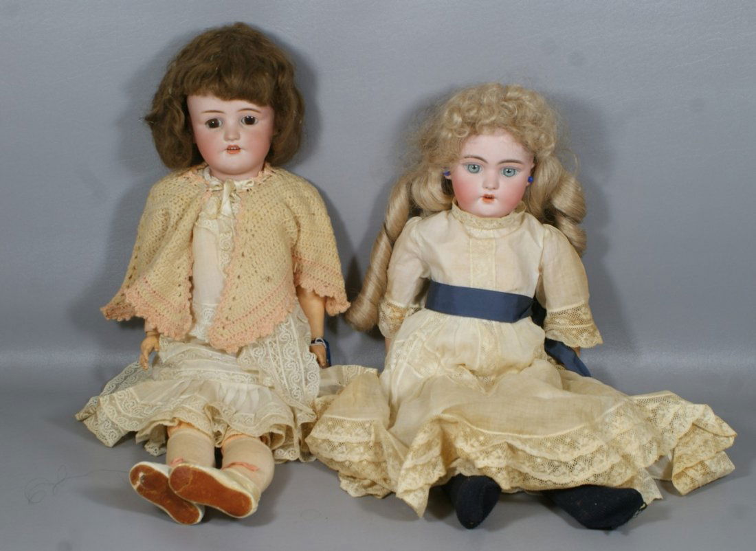 2 German Bisque Head Dolls, larger incised "550 Simon a: 2 German Bisque Head Dolls, larger incised "550 Simon and Halbig" with brown glass sleep eyes, open mouth with 4 upper teeth, painted lower lashes with silk upper lashes on original fully jointed wood