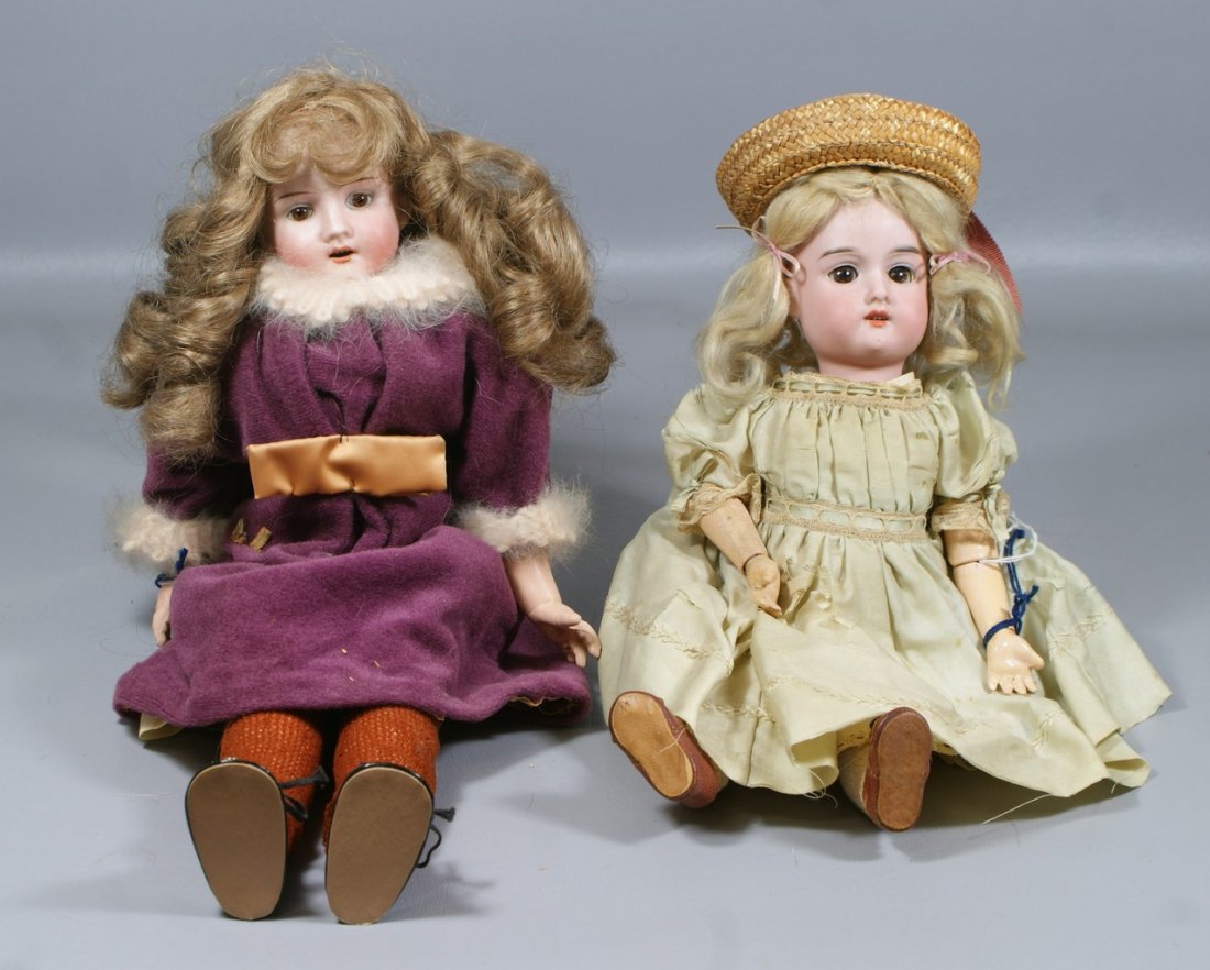 2 German Bisque Head Dolls, the smaller in green dress : 2 German Bisque Head Dolls, the smaller in green dress incised "FloraDora A 2 M" with brown glass sleep eyes, open mouth with 4 teeth on a fully jointed wood and compo body, larger is incised "RA" fix