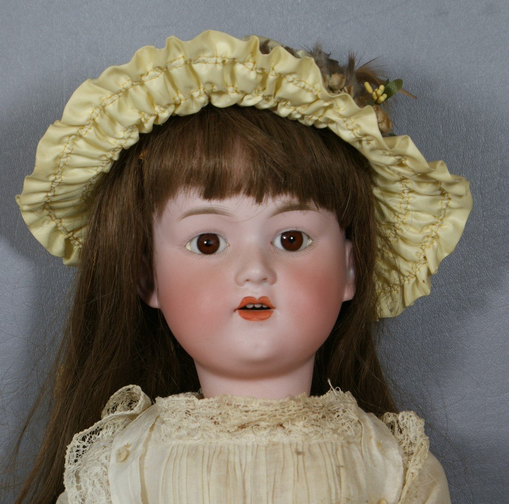 German bisque socket head doll incised "Germany G B" re: German bisque socket head doll incised "Germany G B" reset stationary brown glass eyes, open mouth with 4 teeth on a fully jointed wood and compo body, wearing antique dress with replacement brown hum