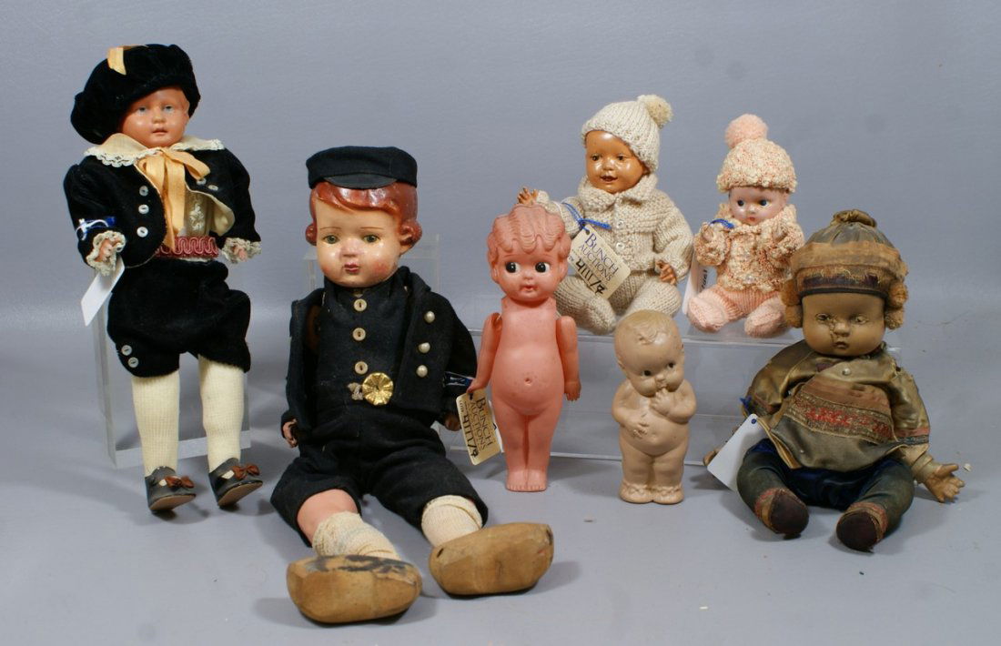 7 Dolls Mostly Compo or Celluloid, largest is a compo d: 7 Dolls Mostly Compo or Celluloid, largest is a compo doll dressed in a Dutch boy outfit, along with a compo Asian baby, another compo baby, 3 all celluloid dolls and a rubber squeak toy baby, most sh