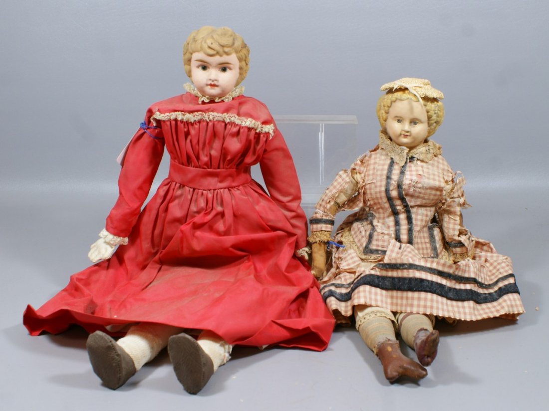 2 Shoulder Head Dolls, the larger is a painted tin head: 2 Shoulder Head Dolls, the larger is a painted tin head impressed "Germany 6" on a cloth body, the smaller is a German papier mache with painted and molded blond hair on stuffed muslin body with leath