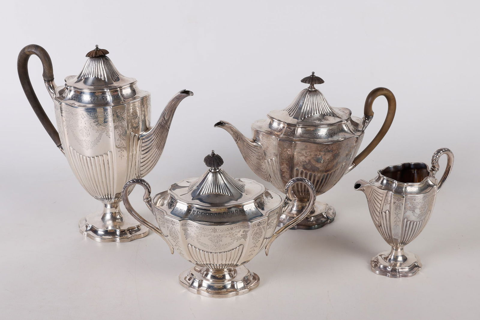 (4) Piece Sterling Tea Service: (4) Piece Sterling Tea Service, Frederick Elkington, 1888, on shaped foot with gadrooned body, in chased bellflower and garland design, with monogram, trimmed in petal design with gadrooned covers, in