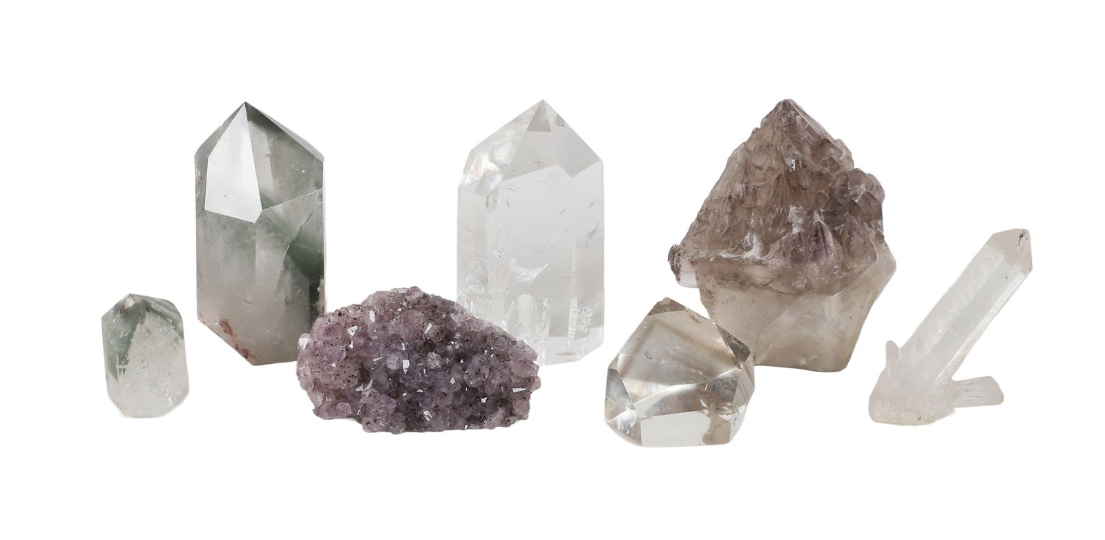 (7) Quartz Portions: (7) Quartz Portions to include an amethyst cluster, 4 1/2"L x 2 1/2"H x 1 1/4"D, (2) chlorite quartz points, 5 1/4"H x 3" dia and 2 3/8"H x 1 1/2" dia, (3) clear quartz portions, 5 1/4"H x 2 5/8" dia