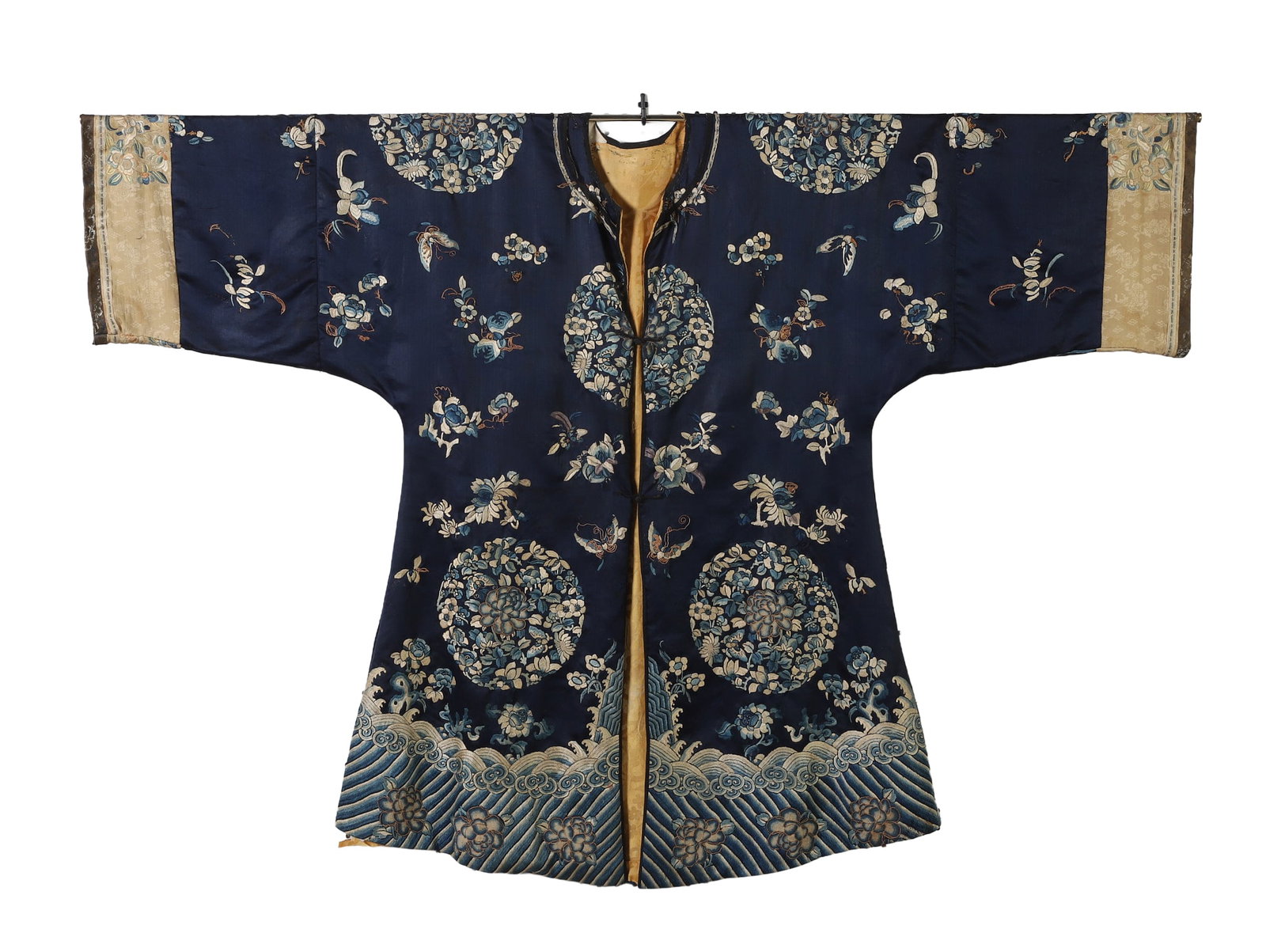 A Chinese Embroidered Ladies' Surcoat: A Chinese embroidered ladies' surcoat, Qing dynasty, in wave trim embroidery, the body of the robe in various embroidery techniques depicting assorted flowers and butterflies, in bullion embroidery hi