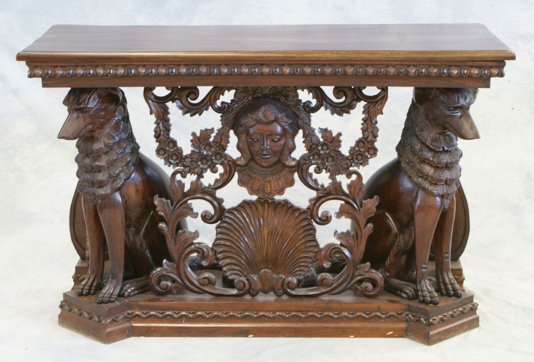 Carved mahogany console table with seated dogs flanking