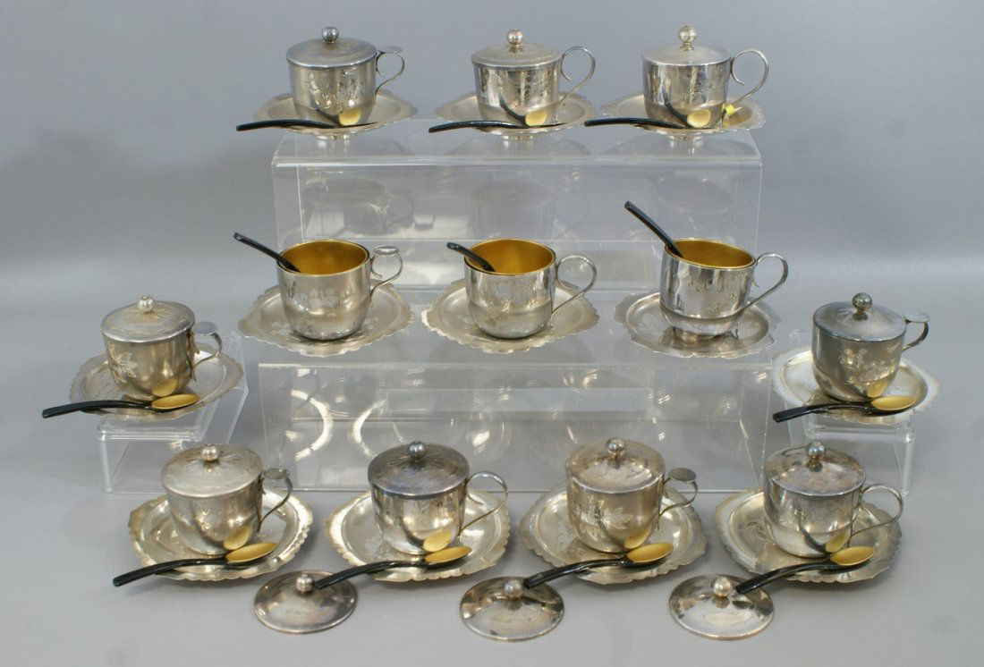 Cased set 12 Japanese silver tea cups and saucers, lacq: Cased set 12 Japanese silver tea cups and saucers, lacquered liners and spoons, unknown assay, saucers signed, no other marks, in a fitted case, 58.3 TO