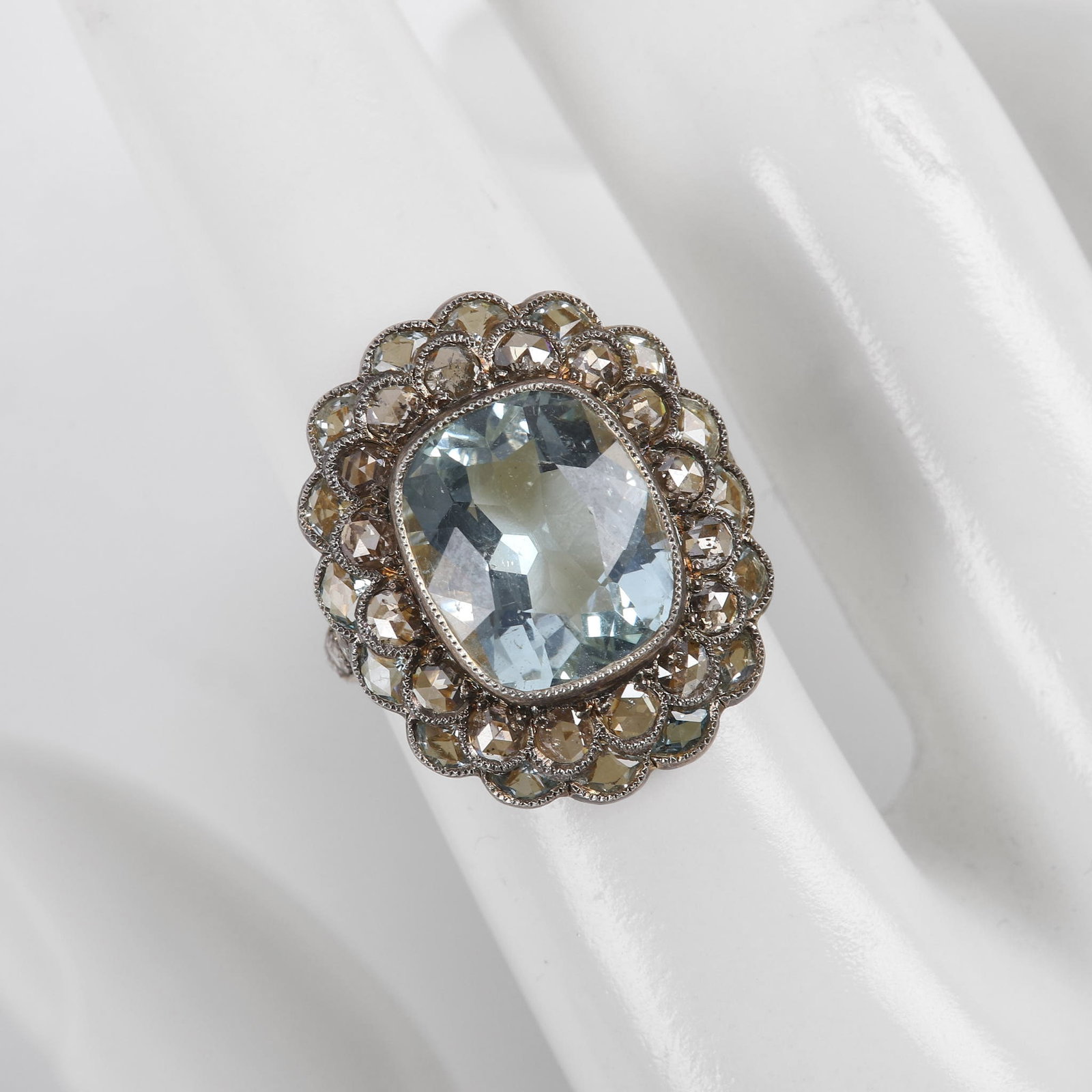 Edwardian Style Cushion Cut Aquamarine Ring: Edwardian Style Cushion Cut Aquamarine Ring, a 12 CTW aquamarine center stone in rose cut diamond and aquamarine scalloped and milgrain surround, rose cut diamond set shoulders, comprised of gilt ster