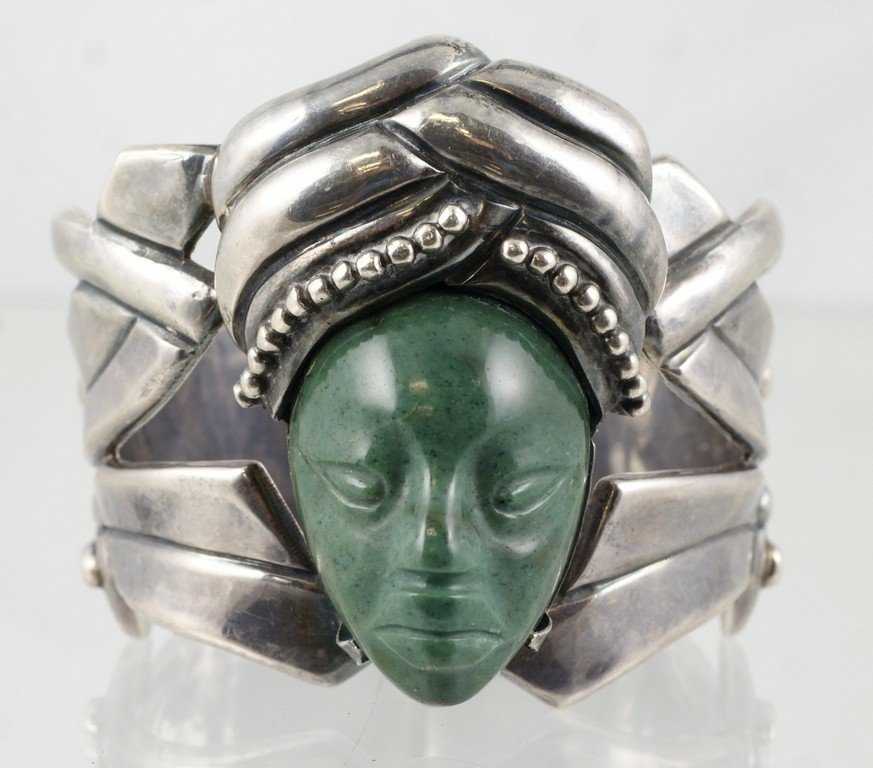 Mexican sterling silver hinged cuff bracelet with: Mexican sterling silver hinged cuff bracelet with carved green stone head, marked "Sterling / 925", 3.24 TO