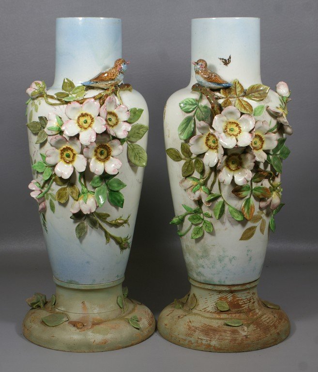 Leon Castel, a pair of stoneware majolica vases with: Leon Castel, a pair of stoneware majolica vases with birds, butterflies and more, made in Cannes France, circa 1900, drilled for lamps with old custom made carved and painted wood bases, approx 17" h,