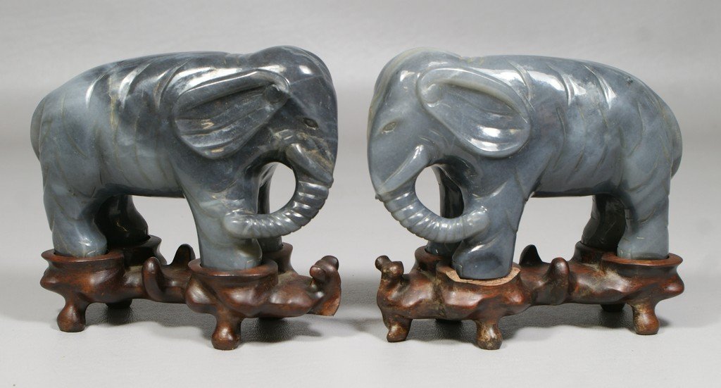 Pair of Chinese Carved Hardstone Elephants on fitted: Pair of Chinese Carved Hardstone Elephants on fitted teakwood stands, chip to one stand, approx 3-1/2" high