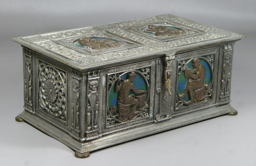 Patinated and silvered bronze dresser box by Oscar Bach: Patinated and silvered bronze dresser box by Oscar Bach Box, panel decoration depicting the arts, sculpture, literature etc, with 6 circular rondels with enameled backs, mahogany lined, 10-1/4" w, 6-1