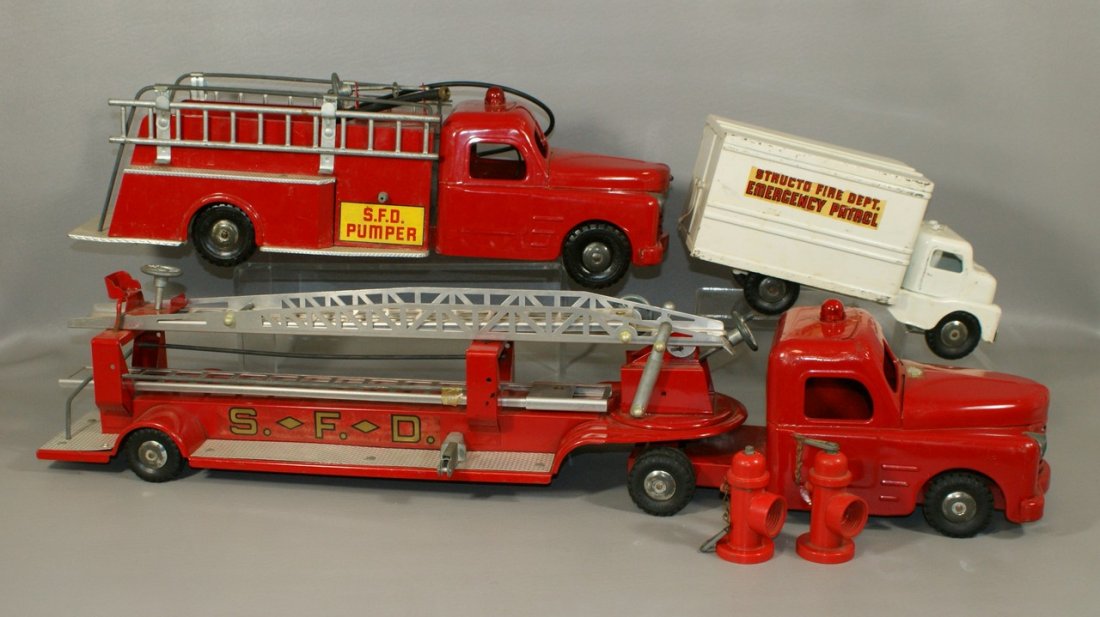 Structo No 570 6 Pc Fire Department pressed steel and: Structo No 570 6 Pc Fire Department pressed steel and cast metal truck set, containing only the SFD Pumper, SFP Ladder Truck, SFD Emergency Patrol, and 2 hydrants, excellent condition, in original box