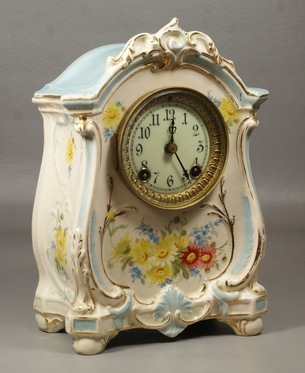 Ansonia Royal Bonn La Roda china case clock,: Ansonia Royal Bonn La Roda china case clock, cylindrical movement with porcelain dial, runs and strikes when wound, 10 3/4" h, small piece glued back on at crest