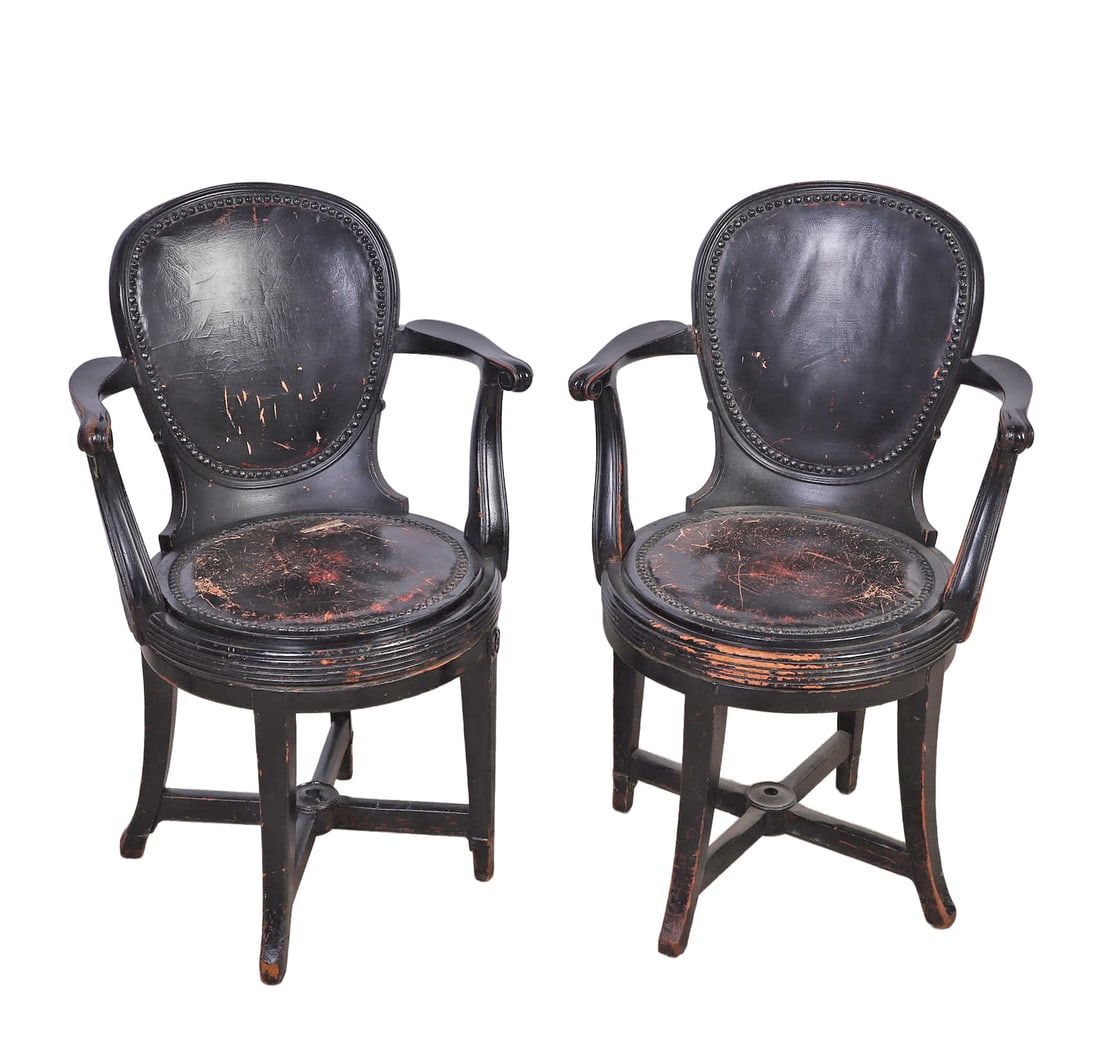 Pair Antique Continental Swivel Armchairs: Pair Antique Continental Swivel Armchairs Pair Continental ebonized wood armchairs, oval backs, scrolled arms, fluted legs, brass tack trim around seat and back and upholstered leather seat and back,