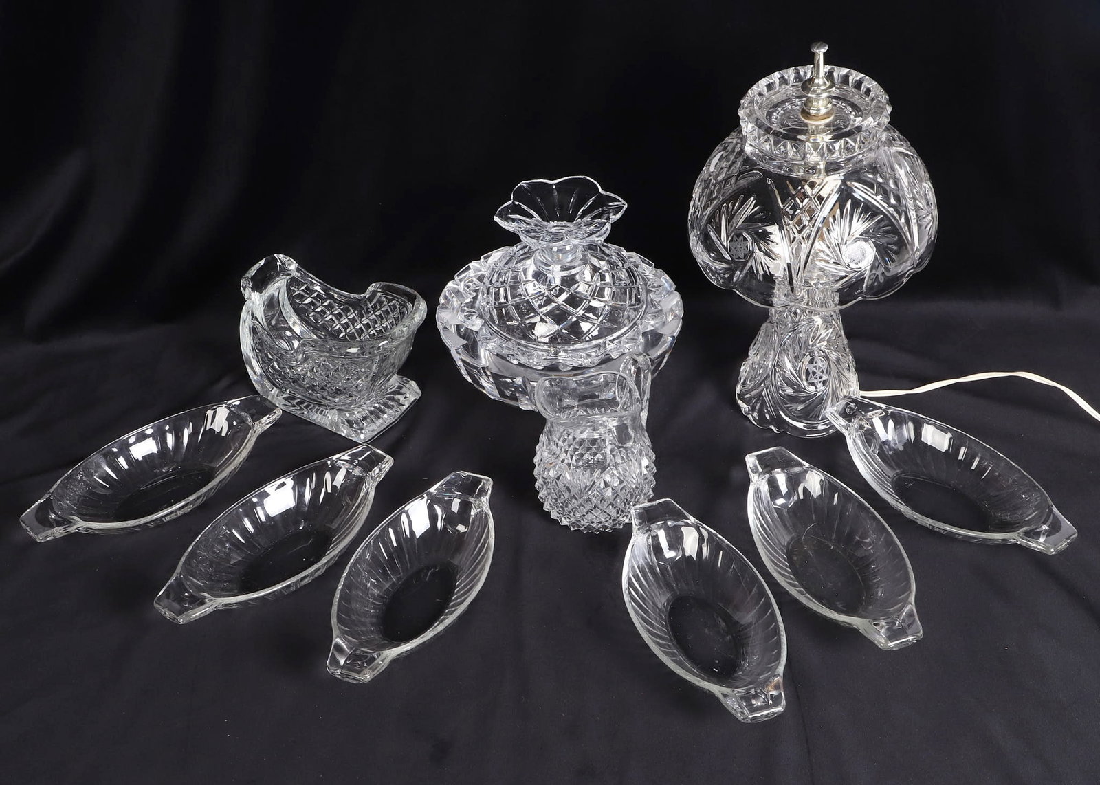 (11) Glassware Feat. Pressed Glass: (11) Glassware Feat. Pressed Glass (10) Lot of glassware inc. a 13 1/2"H lead glass boudoir table lamp with pinwheel design, a thick 8 1/2"W bowl, a set of (6) 9 1/4"L celery plates, & more.