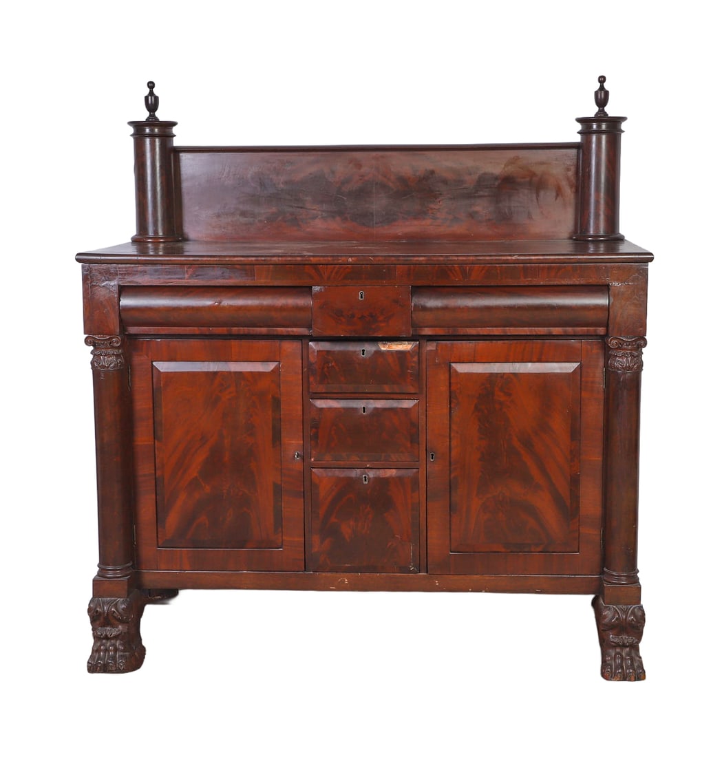 Antique American Empire Sideboard: Antique American Empire Sideboard 19th C. Flame mahogany case with 6 drawers and 2 blind doors. Incorporating Corinthian pilasters that terminate in carved lion's paw feet. Grand scale. Size: 64.5" Hi