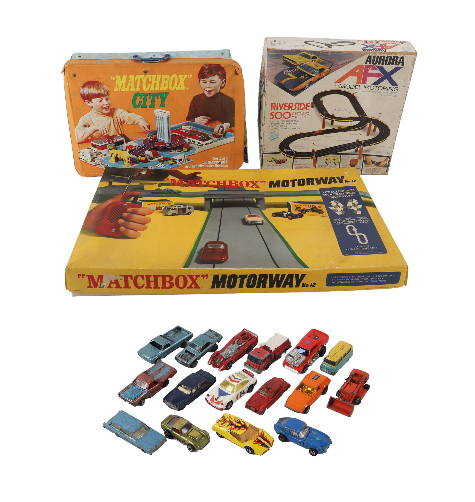Vintage Toy Car & Racing Lot: Vintage Toy Car & Racing Lot Collection of vintage toy cars & racetracks to include: 1) Aurora AFX Riverside 500 electric Ho racing set with track, worn manual and assorted pieces. 2) Matchbox Motorwa