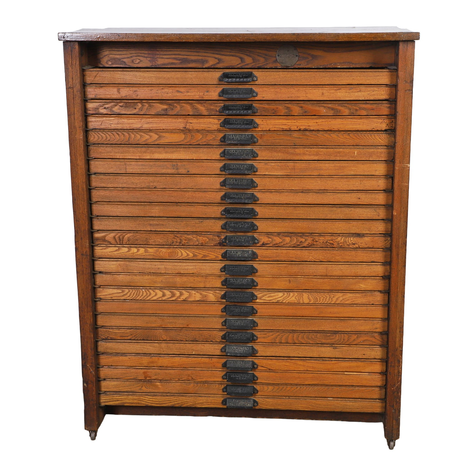 Hamilton Mfg. Printer's Typeset Cabinet: Hamilton Mfg. Printer's Typeset Cabinet Letterpress printer's cabinet with 24 drawers. Oak and pine case with cast-iron pulls on casters. Perfect for a collector's specimen cabinet. 45.5" H x 36" W x 