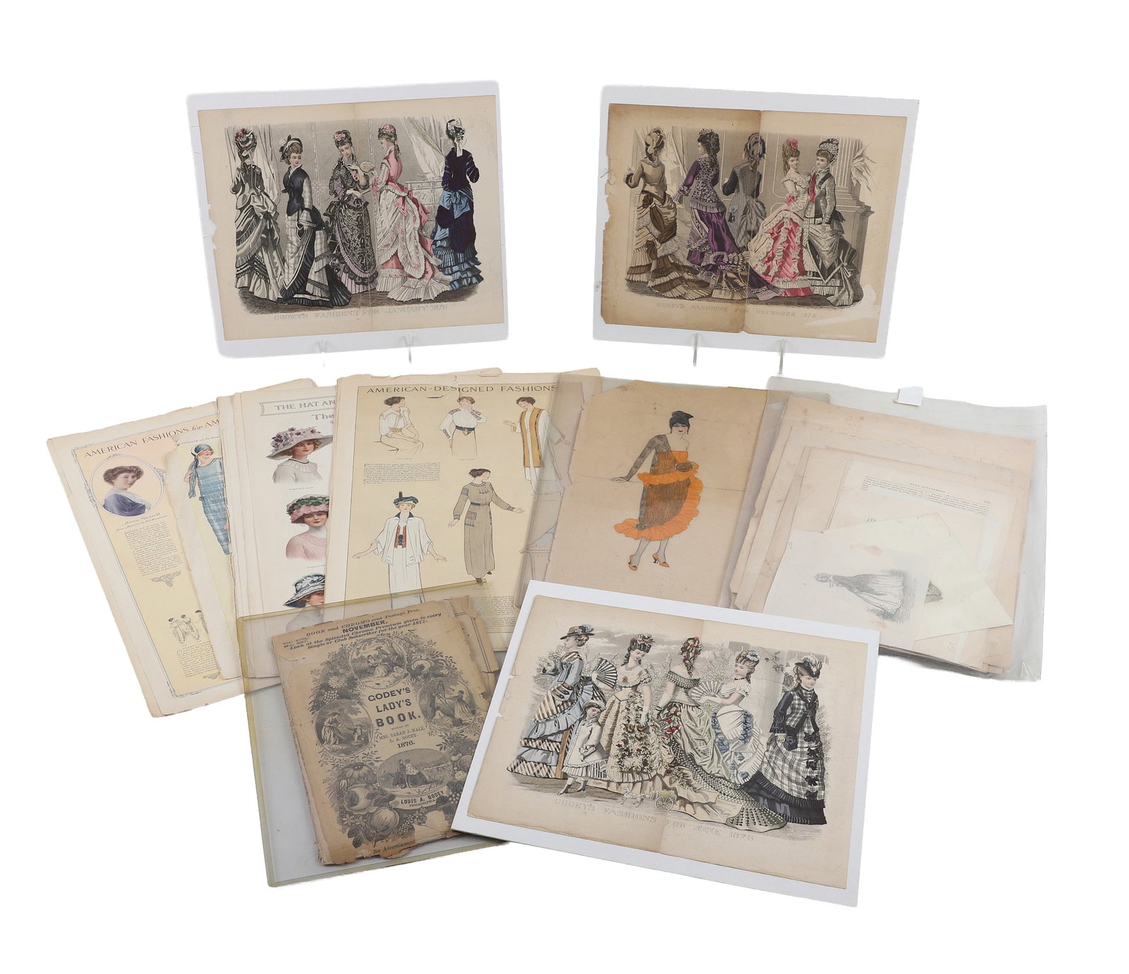 Antique Fashion Ephemera Lot: Antique Fashion Ephemera Lot Collection of antique ephemera having to do with fashion. Includes Godey's fashion prints w/ 1876 'Godey's Lady Book' as well as an assortment of magazine cuttings, advert