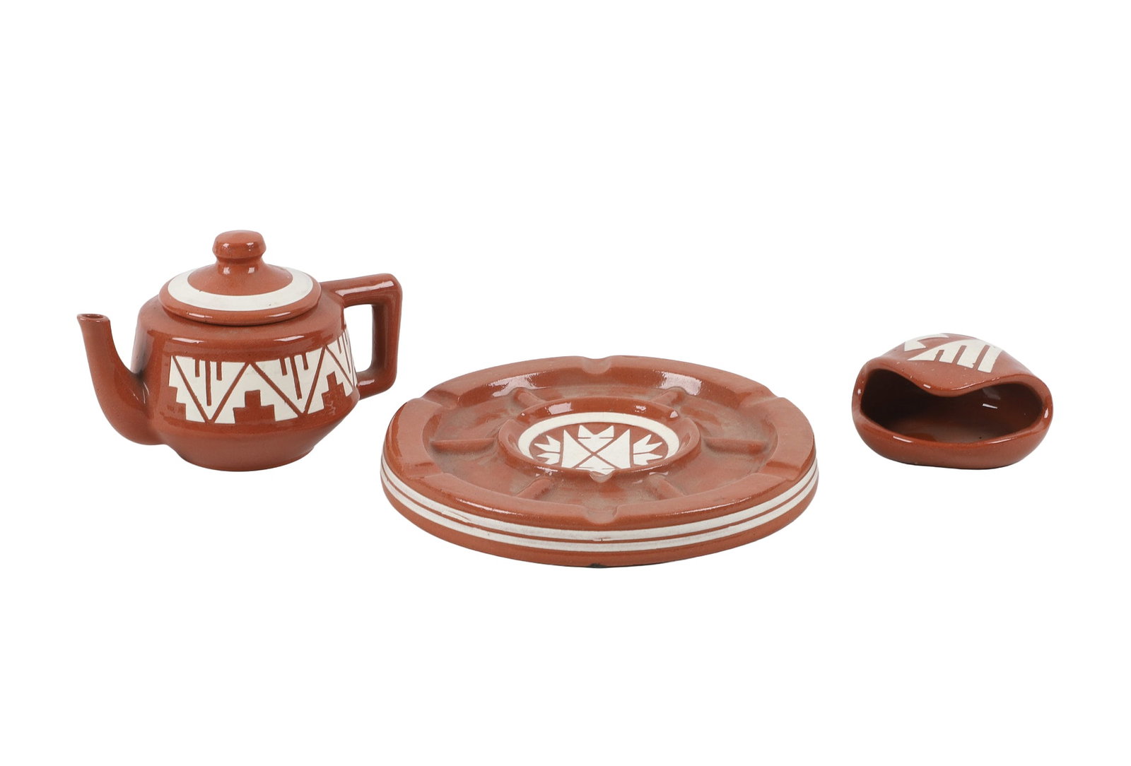 (3) Sioux Ceramics: (3) Sioux Ceramics (3) Matching Sioux marked ceramics including a 6"L teapot, 7 1/2" ashtray, and a spoon rest. Makers marks on underside of each.