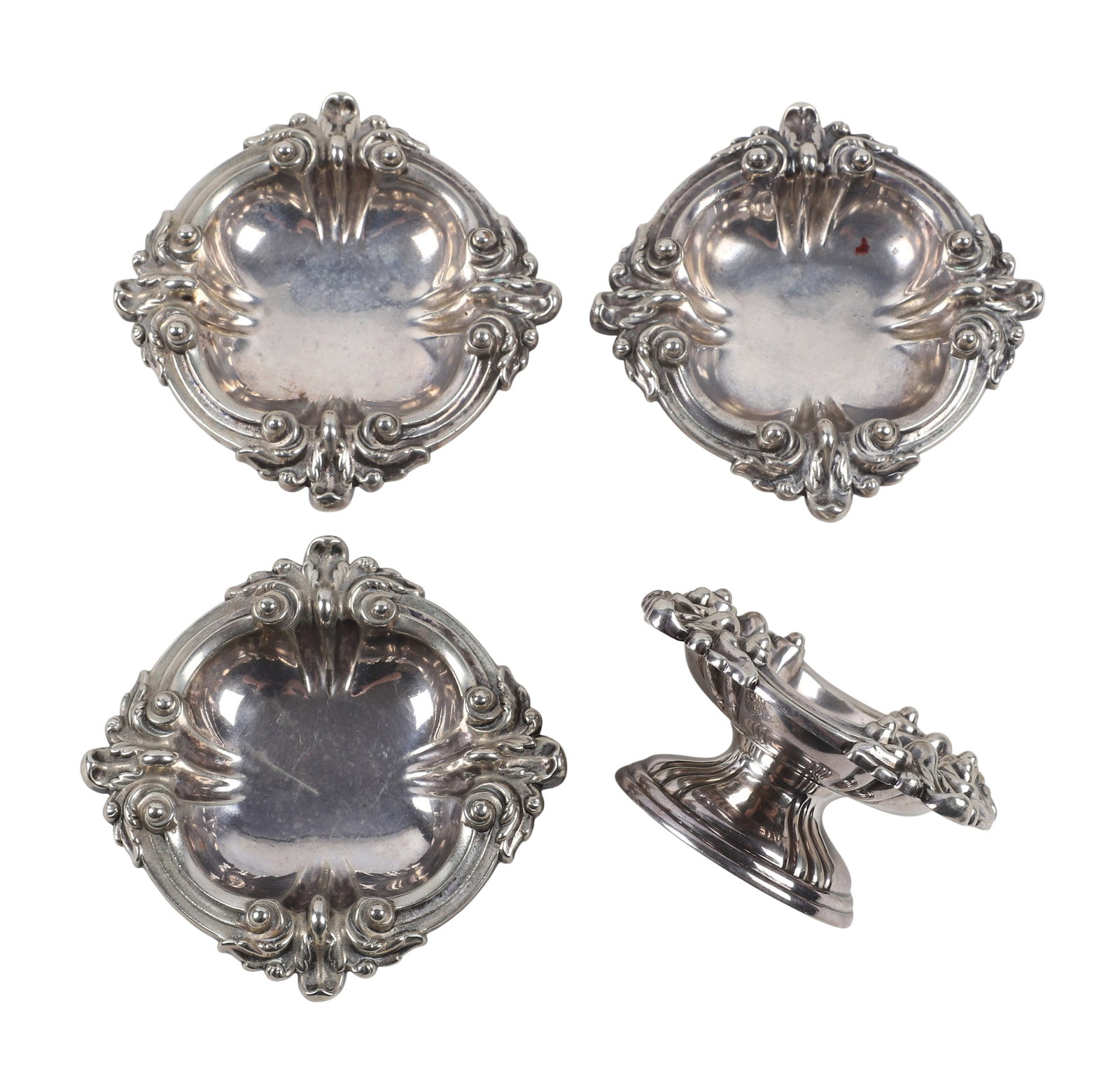 Set of 4 Tiffany & Co. Silver Footed Bon Bon Dishes / Master Salts.: Set of 4 Tiffany & Co. Silver Footed Bon Bon Dishes / Master Salts. With a rococo-revival scrolling acanthus pattern originally dating to approx 1892. The set is marked in 3 ways - a pair with "11018